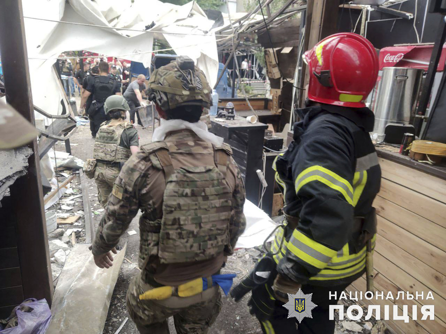 In this photo provided by the National Police of Ukraine, emergency services work at the RIA Pizza restaurant destroyed by a Russian attack in Kramatorsk, Ukraine, Wednesday, June 28, 2023.
