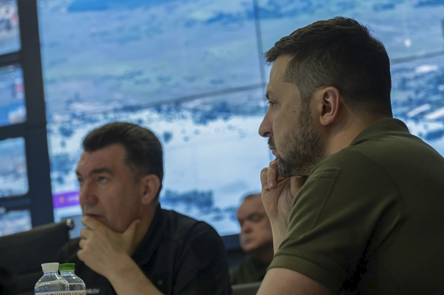 In this photo provided by the Ukrainian Presidential Press Office, Ukrainian President Volodymyr Zelenskyy, right, chairs the emergency meeting of the National Security and Defense Council on the situation at the Kakhovka HPP after the dam was blown up overnight, in Kyiv, Ukraine, Tuesday, June 6, 2023.