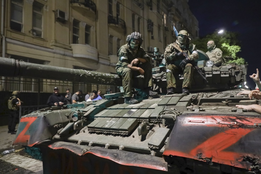 FILE - Membes of the Wagner Group military company sit atop of a tank on a street in Rostov-on-Don, Russia, Saturday, June 24, 2023, prior to leaving an area at the headquarters of the Southern Military District.