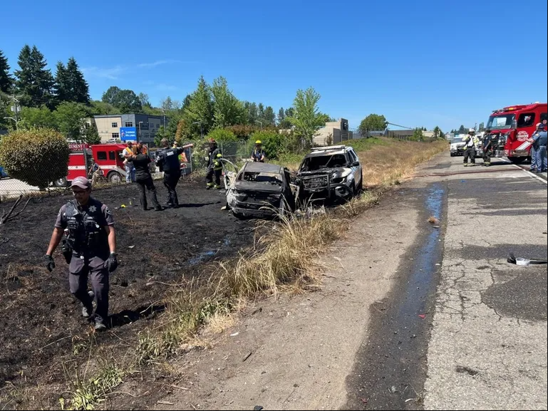 Two patrol cars caught on fire after a police pursuit of a suspected armed carjacker on I-5 near Tacoma on Monday afternoon.