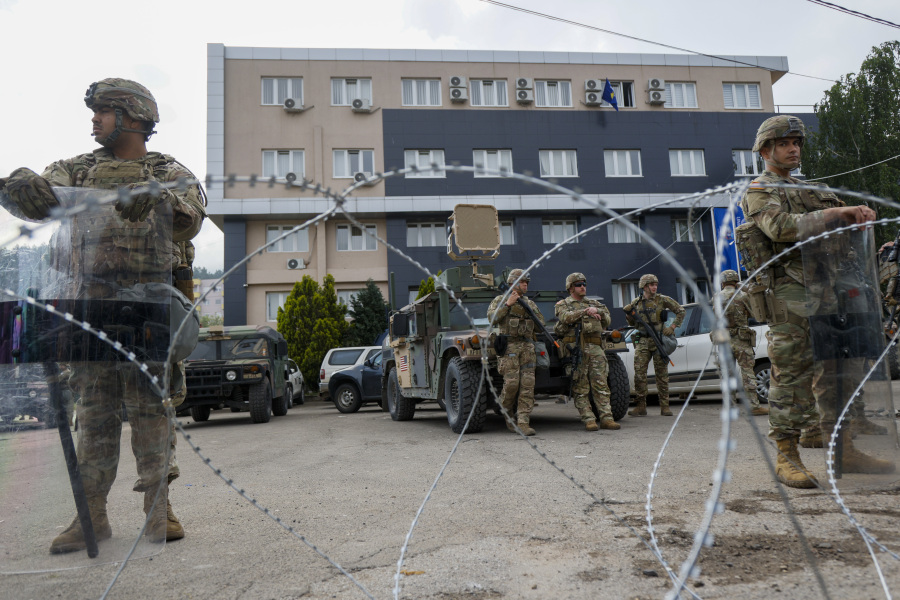 U.S. soldiers -- part of the peacekeeping mission in Kosovo, known as KFOR -- guard a municipal building in the town of Leposavic, northern Kosovo, on May 29. The leaders of Serbia and Kosovo held emergency talks on Thursday amid fears of a return to open conflict.