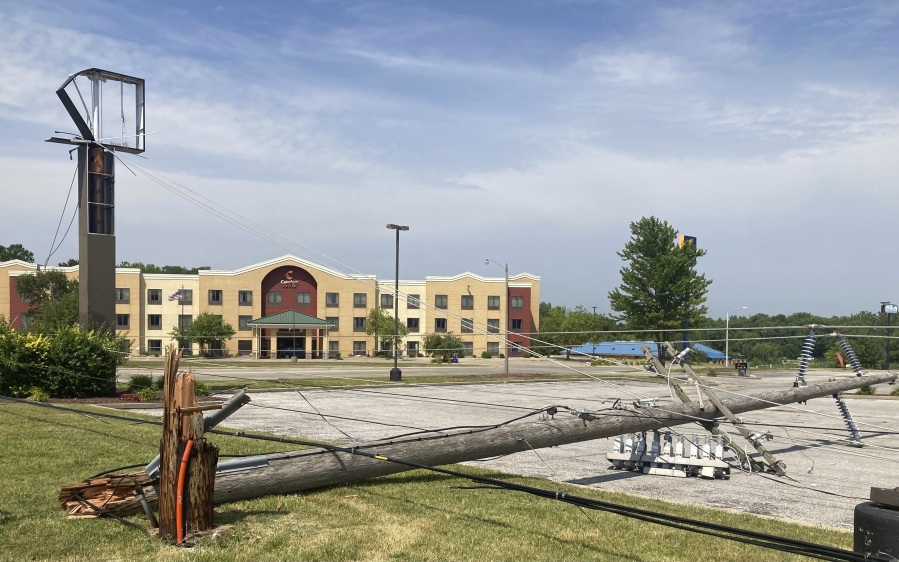 A utility pole lies in a parking lot on Friday, June 30, 2023, snapped off in derecho winds that hit Springfield, Ill., a day earlier along with a string of others on an east-side commercial strip just west of Interstate 55.