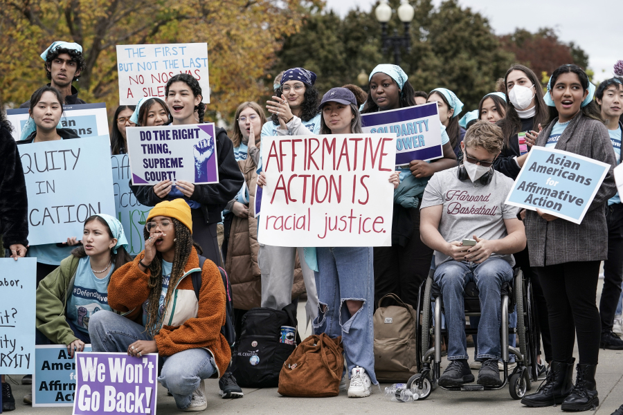 FILE - Activists demonstrate as the Supreme Court hears oral arguments on a pair of cases that could decide the future of affirmative action in college admissions, in Washington, Oct. 31, 2022. (AP Photo/J.