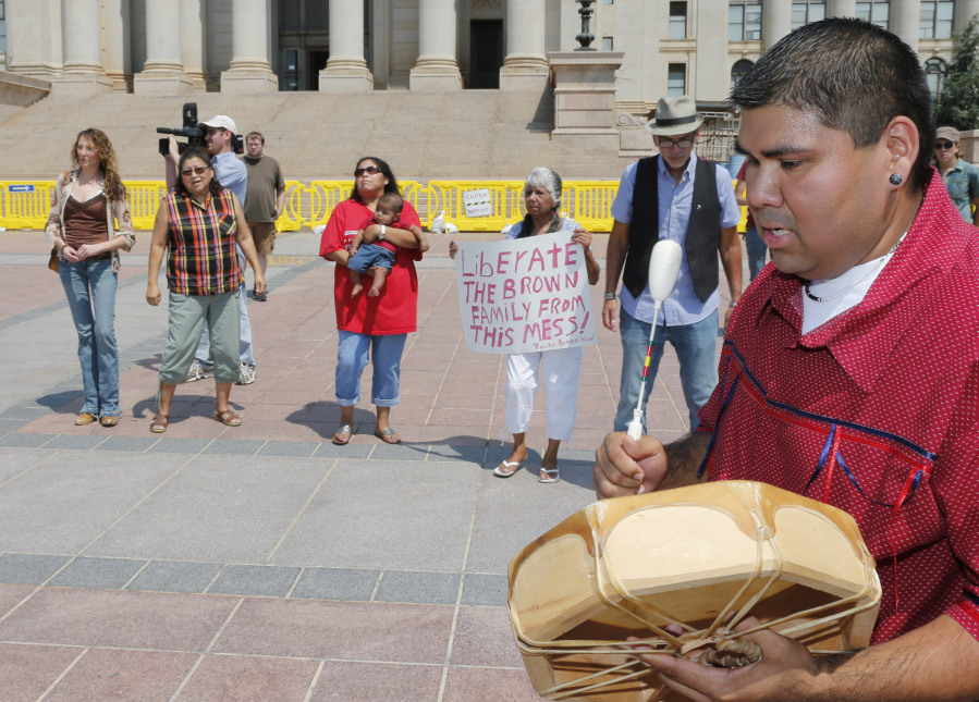 FILE - Chebon Kernell beats a drum and sings during a rally in support of three-year-old baby Veronica, Veronica's biological father, Dusten Brown, and the Indian Child Welfare Act, in Oklahoma City, Aug. 19, 2013. Brown is trying to maintain custody of the girl who was given up for adoption by her birth mother to a couple in South Carolina. The Supreme Court on Thursday, June 15, 2023, preserved the 1978 Indian Child Welfare Act, which gives preference to Native American families in foster care and adoption proceedings of Native children, rejecting a broad attack from Republican-led states and white families who argued it is based on race.