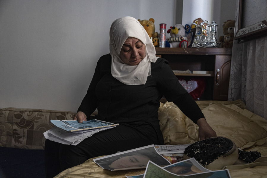 Hamrin Alouji, the mother of 13-year-old Peyal Aqil, goes through her daughter's photographs at their family home in Qamishli, Syria, on Monday, June 5, 2023. Alouji said her daughter was coming home with her friends on May 21 after a school exam when a recruiter for the Revolutionary Youth approached her - the youth branch of the Democratic Union Party (PYD), and entered a center belonging to the group with him. Her friends waited for her outside, but she never came out.