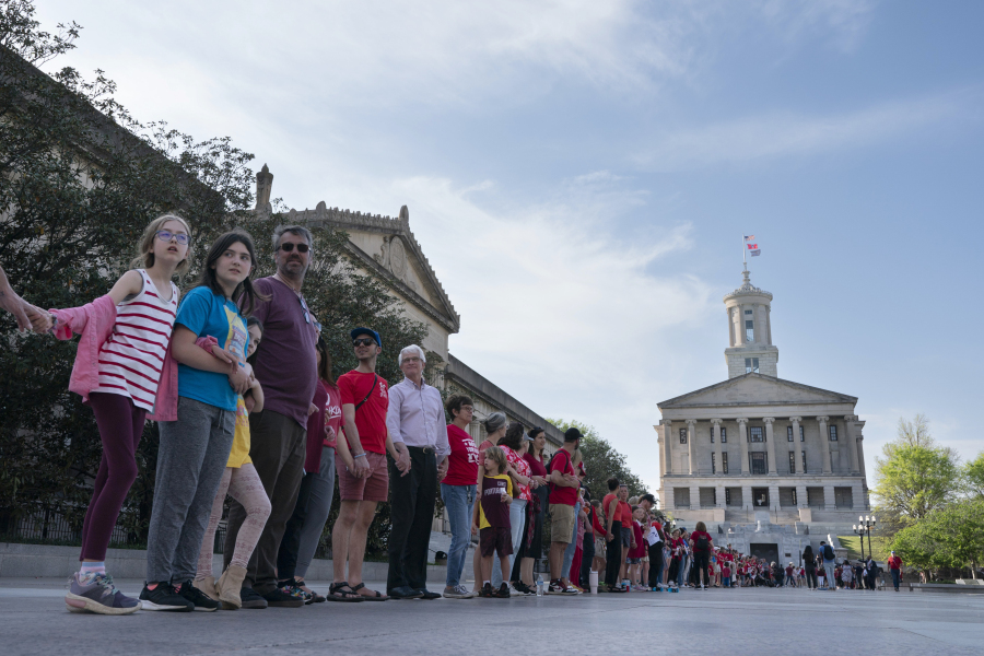 FILE - Demonstrators hold hands and lock arms with each other during the "Arms Are for Hugging" protest for gun control legislation, April 18, 2023, in Nashville, Tenn. Participants created a human chain starting from Monroe Carell Jr. Children's Hospital at Vanderbilt, where victims of The Covenant School shooting were taken on March 27, and ending at the Tennessee Capitol. Documents obtained by The Associated Press show Tennessee Gov.