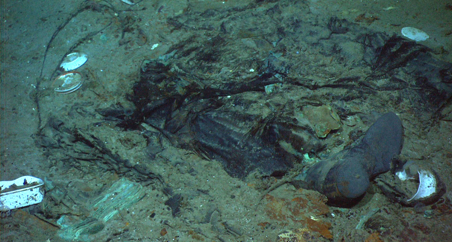 FILE - This 2004 photo provided by the Institute for Exploration, Center for Archaeological Oceanography/University of Rhode Island/NOAA Office of Ocean Exploration, shows the remains of a coat and boots in the mud on the sea bed near the Titanic's stern. A search is underway for a missing submersible that carries people to view the wreckage of the Titanic, according to media reports. The U.S. Coast Guard told BBC News that a search was underway Monday, June 19, 2023, off the coast of Newfoundland.
