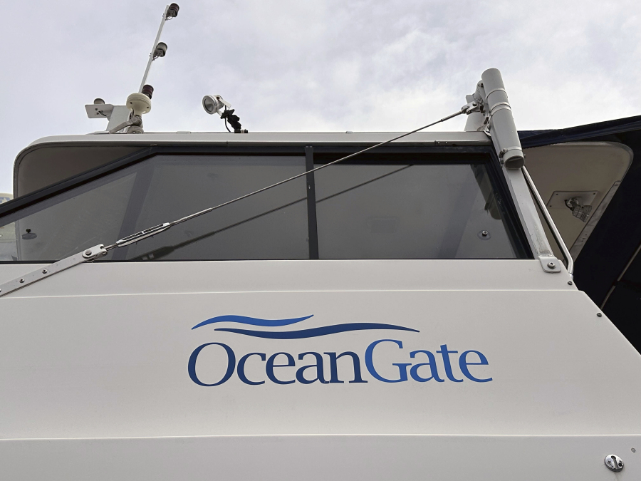 The logo for OceanGate Expeditions is seen on a boat parked near the offices of the company at a marine industrial warehouse office door in Everett, Wash., Tuesday, June 20, 2023. Rescuers raced against time to find the missing submersible carrying five people, who were reported overdue Sunday night.