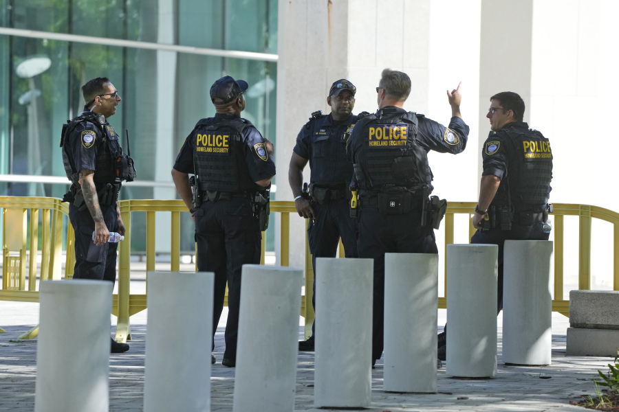 Federal Protective Service Police talk outside the Wilkie D. Ferguson Jr. U.S. Courthouse, Monday, June 12, 2023, in Miami. Former President Donald Trump is set to appear at the federal court Tuesday, on dozens of felony charges accusing him of illegally hoarding classified information.