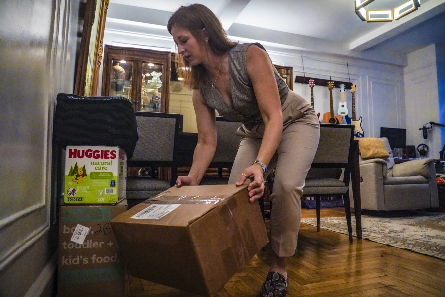Jessica Ray moves deliveries from UPS, including baby food and diapers for her child, in her apartment on Friday, May 12, 2023, in New York. Ray, who relies on delivery for virtually everything, said she is concerned about delays in deliveries should UPS workers strike.