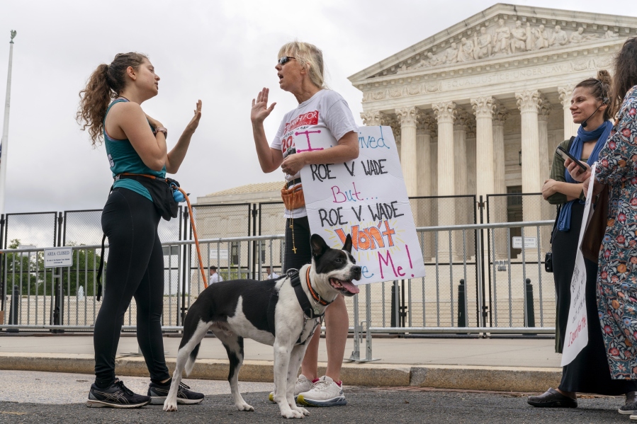 FILE - Lilo Blank, 23, of Philadelphia, left, who supports abortion rights, and Lisa Verdonik, of Arlington, Va., who is anti-abortion, talk about their opposing views on abortion rights, Friday, May 13, 2022, outside the Supreme Court in Washington, ahead of expected abortion rights rallies across the country on Saturday. One year ago, the U.S. Supreme Court rescinded a five-decade-old right to abortion, prompting a seismic shift in debates about politics, values, freedom and fairness.