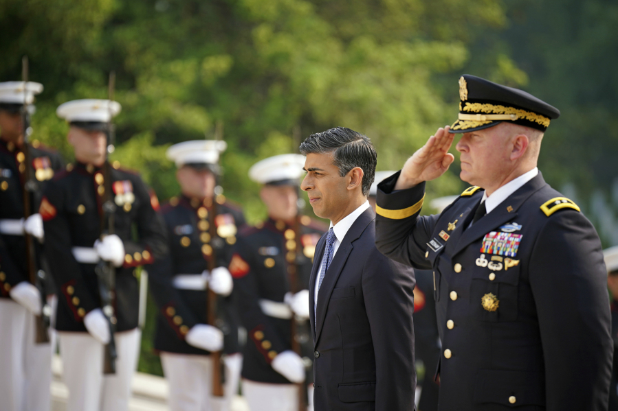 British Prime Minister Rishi Sunak, center left, pays his respects at a wreath at the Tomb of the Unknown Soldier in Arlington National Cemetery during his visit to Washington D.C., Wednesday, June 7, 2023. The war in Ukraine was top Sunak's agenda Wednesday as he started a two-day trip to Washington carrying the message that post-Brexit Britain remains an essential American ally in a world of emboldened authoritarian states.