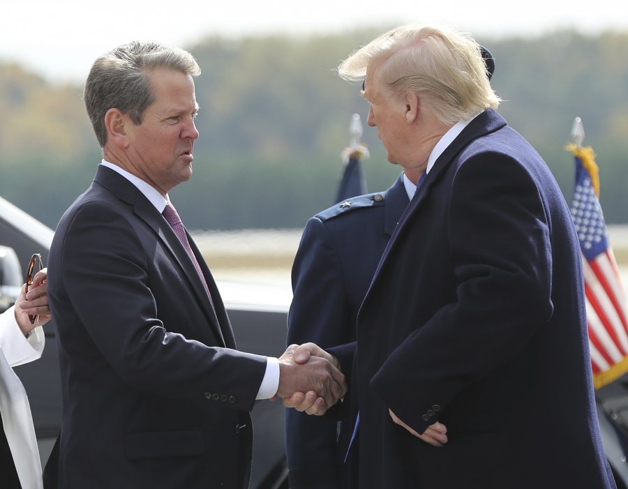 FILE - Georgia Gov. Brian Kemp, left, greets President Donald Trump as he arrives at Dobbins Air Reserve Base on Nov. 8, 2019, in Marietta, Ga. The Republican Kemp is working against Trump's 2024 candidacy and won't appear at a Georgia Republican Party convention in Columbus, Ga., on Saturday, June 10, 2023, where Trump is scheduled to appear.