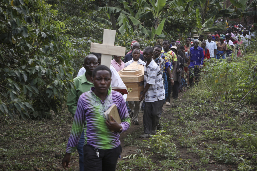 The coffins of Florence Masika and her son Zakayo Masereka, who were both killed by suspected rebels as they retreated from Saturday's attack on the Lhubiriha Secondary School, are carried to their burial in Nyabugando, Uganda Sunday, June 18, 2023. A bereaved Ugandan border town on Sunday began burying the victims of the brutal attack by suspected extremist rebels that left at least 42 people dead, most of them students, as security forces stepped up patrols along the frontier with volatile eastern Congo.