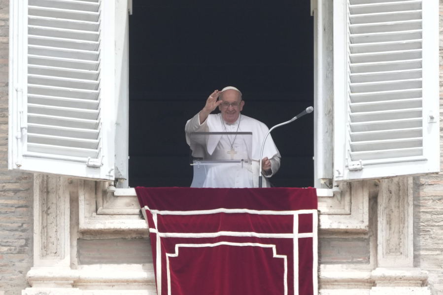 Pope Francis waves to faithful during the Angelus noon prayer in St. Peter's Square at the Vatican, Sunday, June 4, 2023.