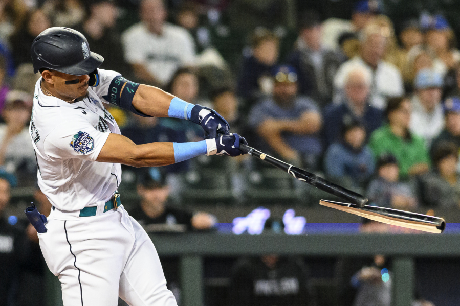 Seattle Mariners' Julio Rodriguez breaks his bat as he flies out against the Chicago White Sox during the first inning of a baseball game, Sunday, June 18, 2023, in Seattle.