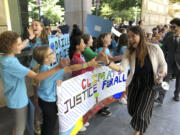 Kelsey Juliana of Eugene, Ore., a lead plaintiff who is part of a lawsuit by a group of young people who say U.S. energy policies are causing climate change and hurting their future, greets supporters outside a federal courthouse, June 4, 2019, in Portland, Ore. A federal judge ruled on Thursday, June 1, 2023, that a lawsuit brought by young Oregon-based climate activists can proceed to trial years after they first filed the lawsuit in an attempt to hold the nation's leadership accountable for its role in climate change.