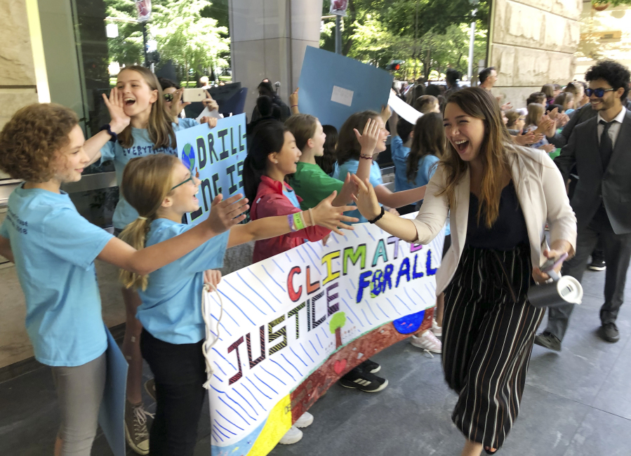 Kelsey Juliana of Eugene, Ore., a lead plaintiff who is part of a lawsuit by a group of young people who say U.S. energy policies are causing climate change and hurting their future, greets supporters outside a federal courthouse, June 4, 2019, in Portland, Ore. A federal judge ruled on Thursday, June 1, 2023, that a lawsuit brought by young Oregon-based climate activists can proceed to trial years after they first filed the lawsuit in an attempt to hold the nation's leadership accountable for its role in climate change.