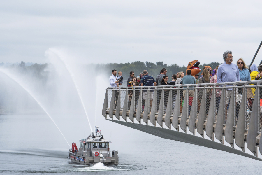 A Vancouver Fire Department fire boat sprays water under the Grant Street Pier at the Waterfront Vancouver grand opening on Sept. 29, 2018.