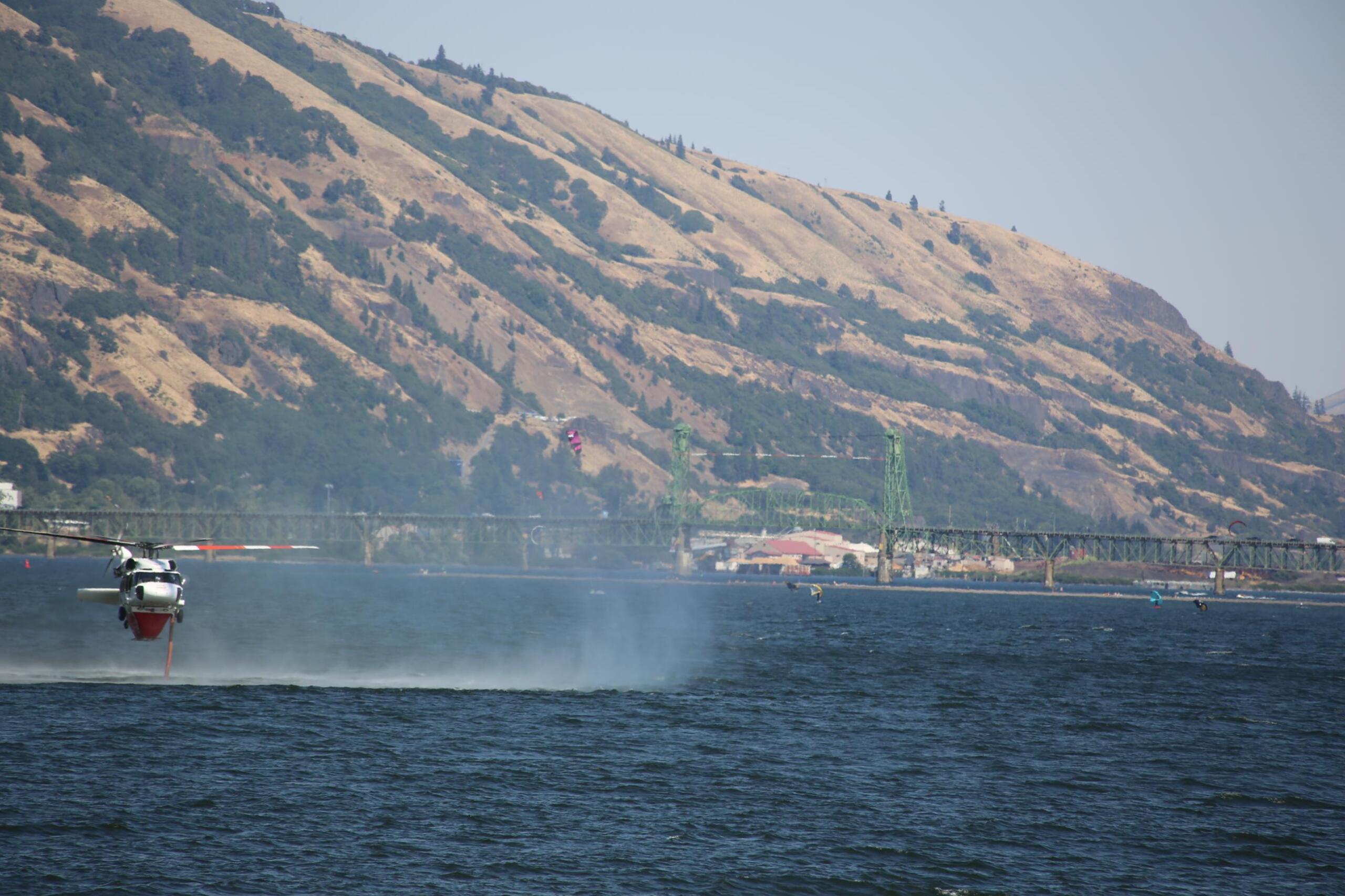 Helicopter dipping water from the Columbia River for the Tunnel Five Fire.