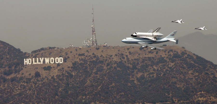 The space shuttle Endeavour passes the Hollywood sign before landing at LAX on Sept. 21, 2012.