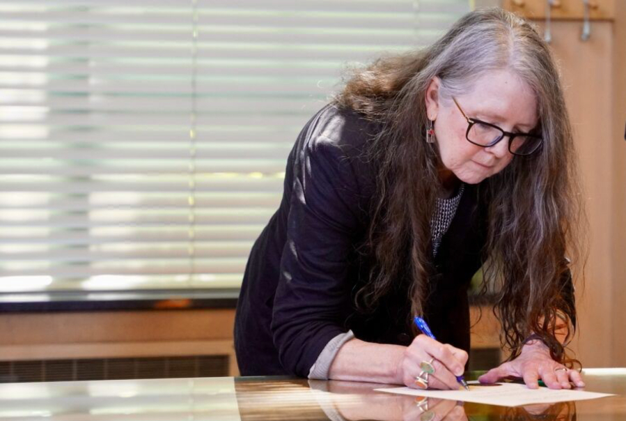 Oregon Secretary of State LaVonne Griffin-Valade signs her oath of office on June 30.