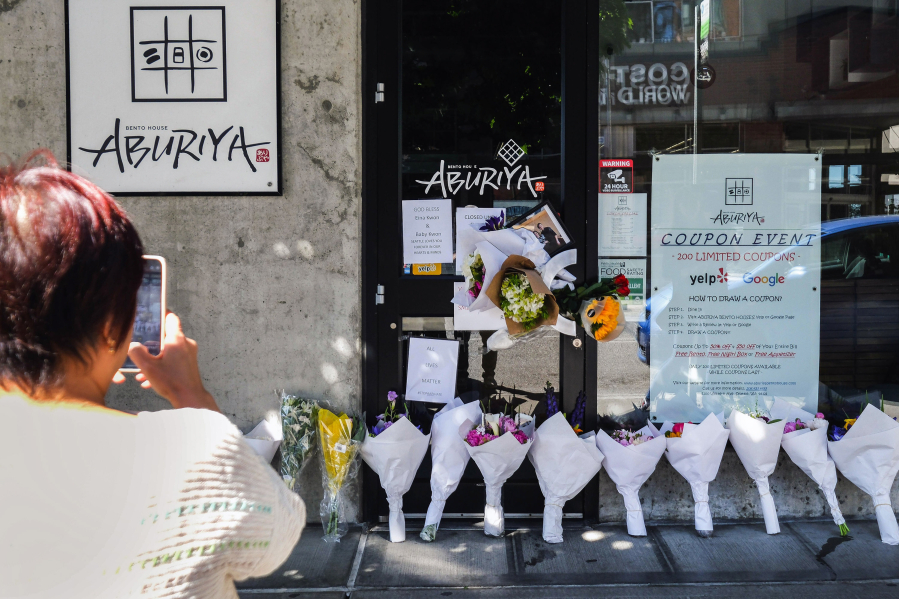 A memorial grows outside a Belltown neighborhood restaurant in Seattle after a June 13 shooting that killed owner Eina Kwon and her unborn daughter, and injured her husband, Sung Kwon.