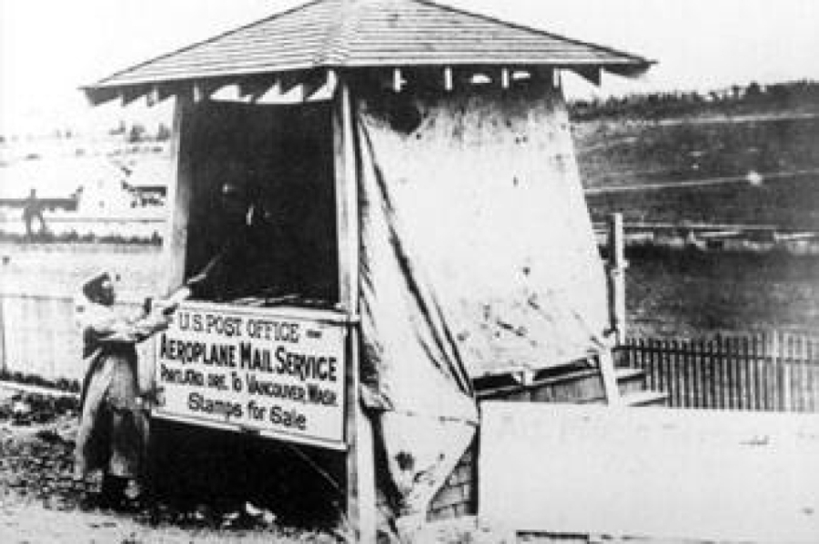 In 1912, a man sold stamps for the first airmail service between Portland and Vancouver. Walter Edwards made this first interstate flight carrying 5,000 uniquely postmarked letters, some with stamps sold from this booth. Official airmail stamps weren't sold until 1918.