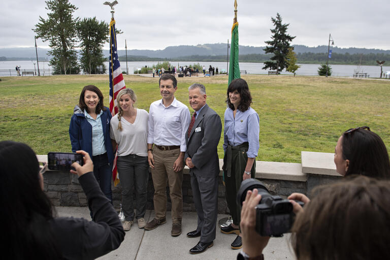 U.S. Sen. Maria Cantwell, from left, pauses for a photo with Elyse Ping Medvigy, U.S. Secretary of Transportation Pete Buttigieg, Clark County Councilor Gary Medvigy, and U.S. Rep. Marie Gluesenkamp Perez at the Port of Camas-Washougal on Friday morning, July 7, 2023. Elyse Ping Medvigy is the daughter of Gary Medvigy. The politicians were in Clark County to celebrate the the $40 million USDOT grant the city received to remove a train-road intersection.