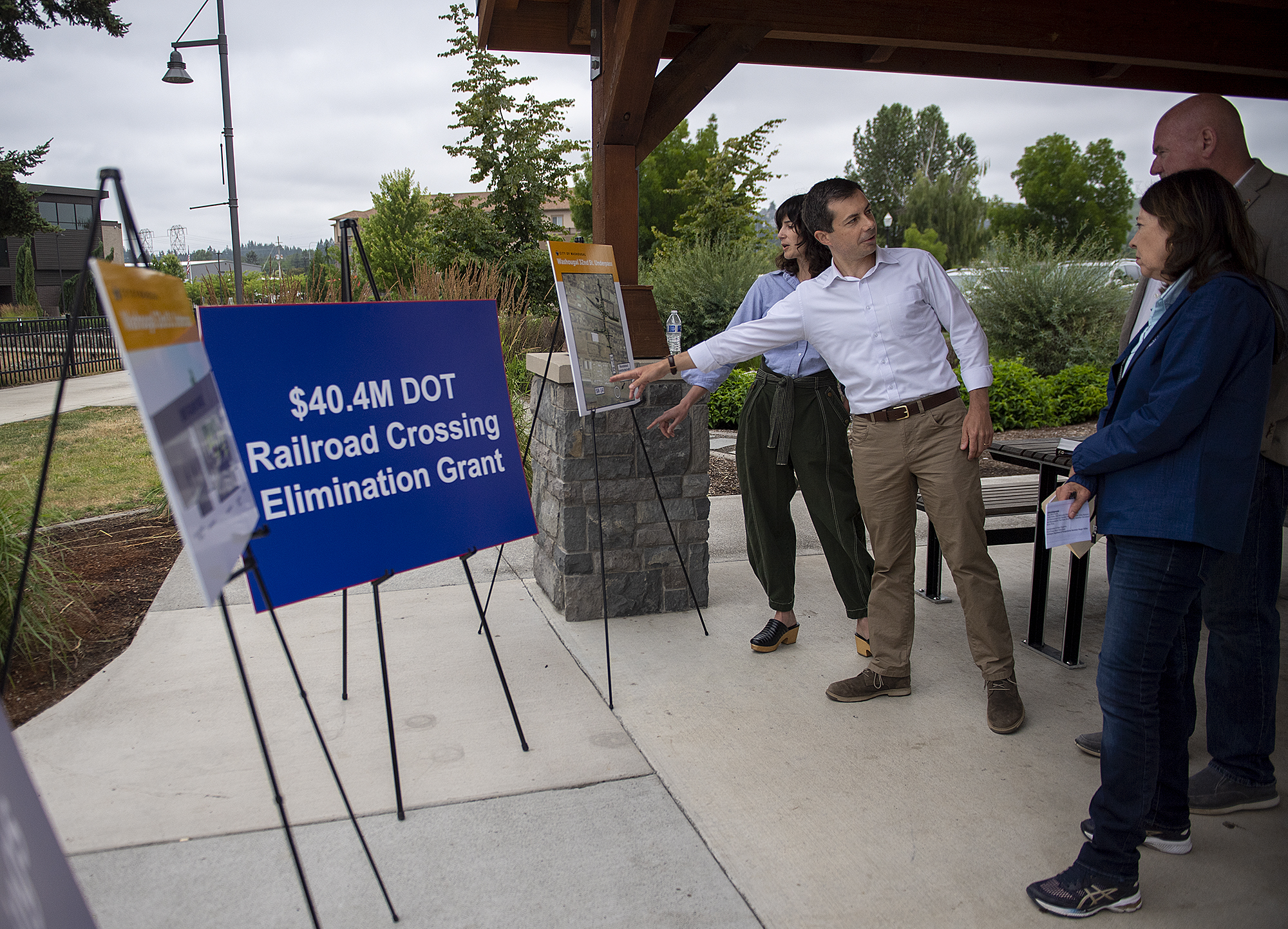 U.S. Rep. Marie Gluesenkamp Perez, from left, and U.S. Secretary of Transportation Pete Buttigieg talk with U.S. Sen. Maria Cantwell and Mayor David Stuebe of Washougal on Friday morning, July 7, 2023. The politicians were in Clark County to celebrate the $40 million USDOT grant the city received to remove a train-road intersection.