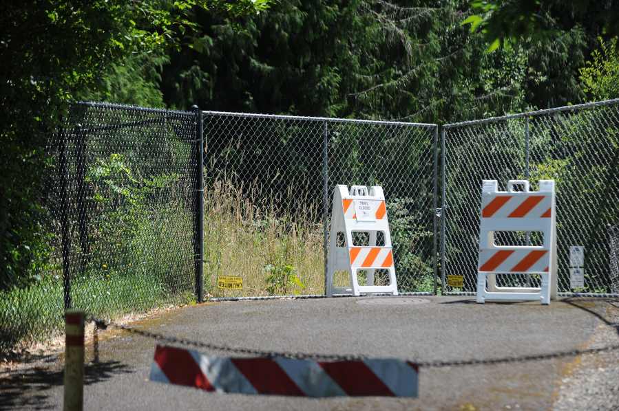 Signs, chains, fencing and a locked gate block access to a section of the Gee Creek trail in Ridgefield. According to city officials, the trail was closed in November after heavy rains eroded slopes along the creek and downed some trees.