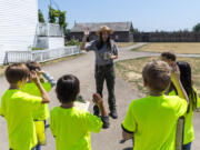 Park guide Sarah Weber has a group of Bike Clark County campers take the junior ranger oath Tuesday at Fort Vancouver National Historic Site.