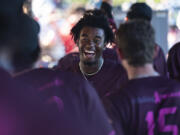 Raptors player Reiss Calvin smiles in the dugout after scoring a run Friday, July 14, 2023, during the Raptors’ game against Yakima Valley at the Ridgefield Outdoor Recreation Complex.
