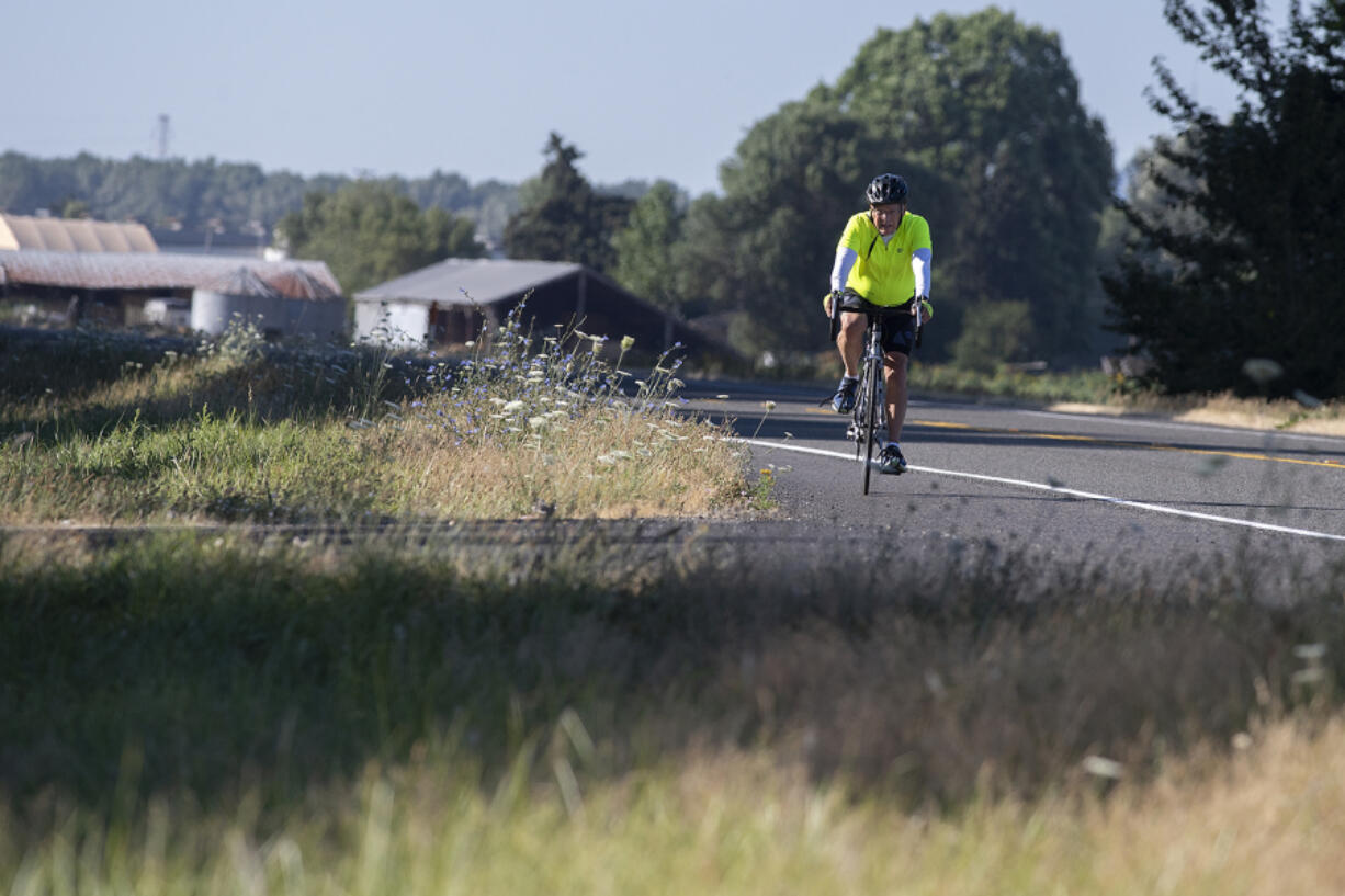 Felida resident Rich Marsee bicycles to Vancouver Lake on Tuesday. He rides six days a week to raise money for Share and FISH Vancouver, agencies that helped his son, Scott, when he was homeless. Scott died in 2022.