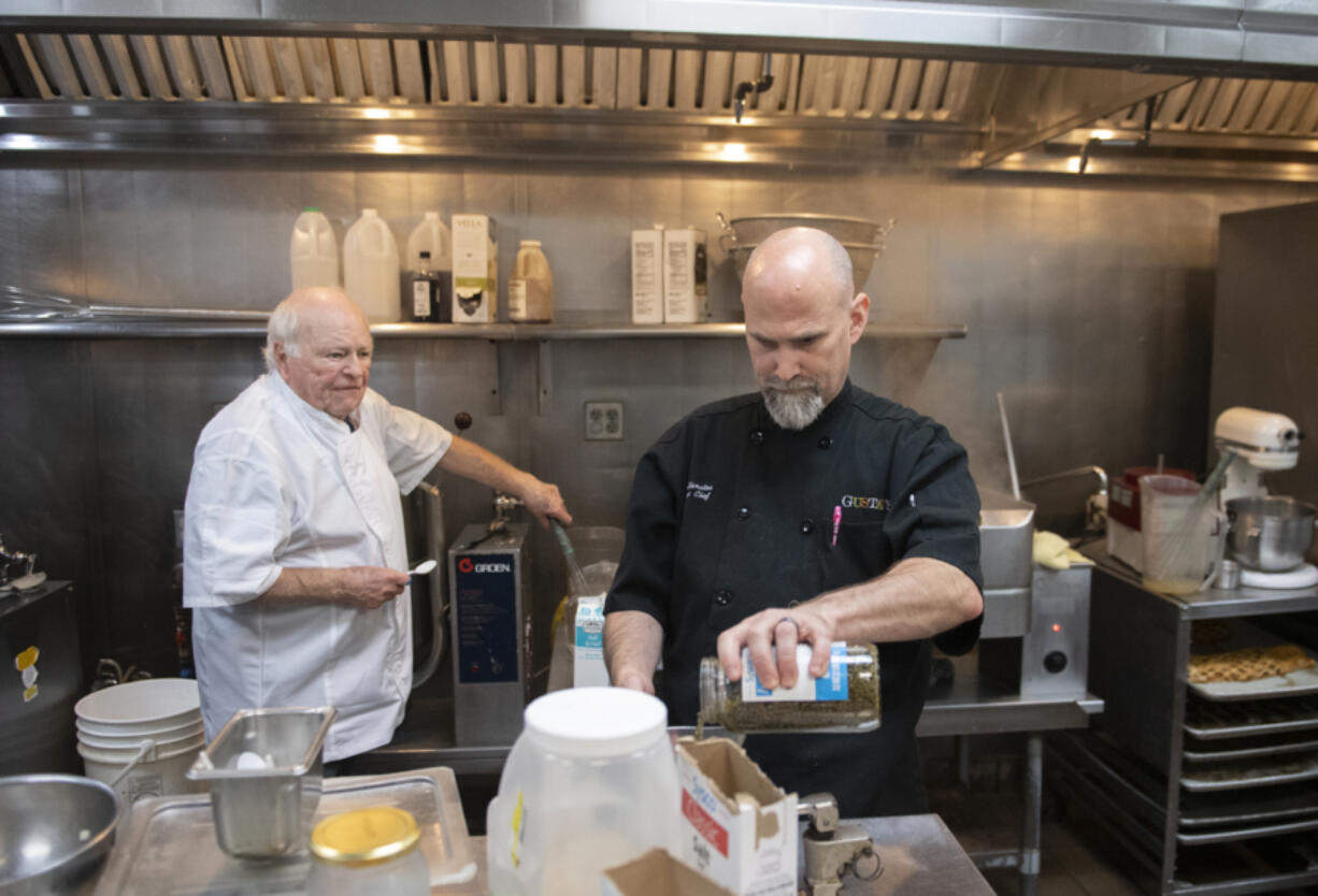 Legendary Portland restaurateur Horst Mager, left, founder of Portland's der Rheinlander, makes German meatballs in the kitchen of Gustav's with Executive Chef Doug Hamilton. The east Vancouver restaurant has a new owner, Genaro Amaro.  Gustav's new menu includes dishes such as New York strip steak, stuffed cabbage rolls, garlic cheese bread, chicken schnitzel and German meatballs in a caper sauce with spaetzle and potato pancakes.