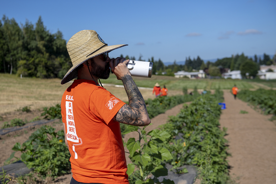 Abdullah Bourahmah of The Home Depot stays hydrated while joining fellow volunteers at 78th Street Heritage Farm.
