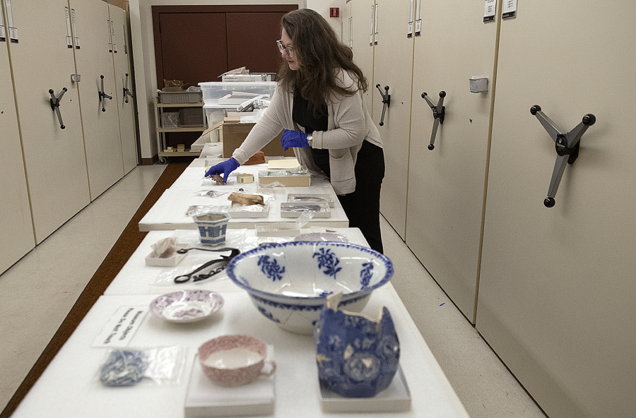 Meagan Huff, museum curator at Fort Vancouver National Historic Site, examines the artifacts that will be included in the upcoming exhibition.