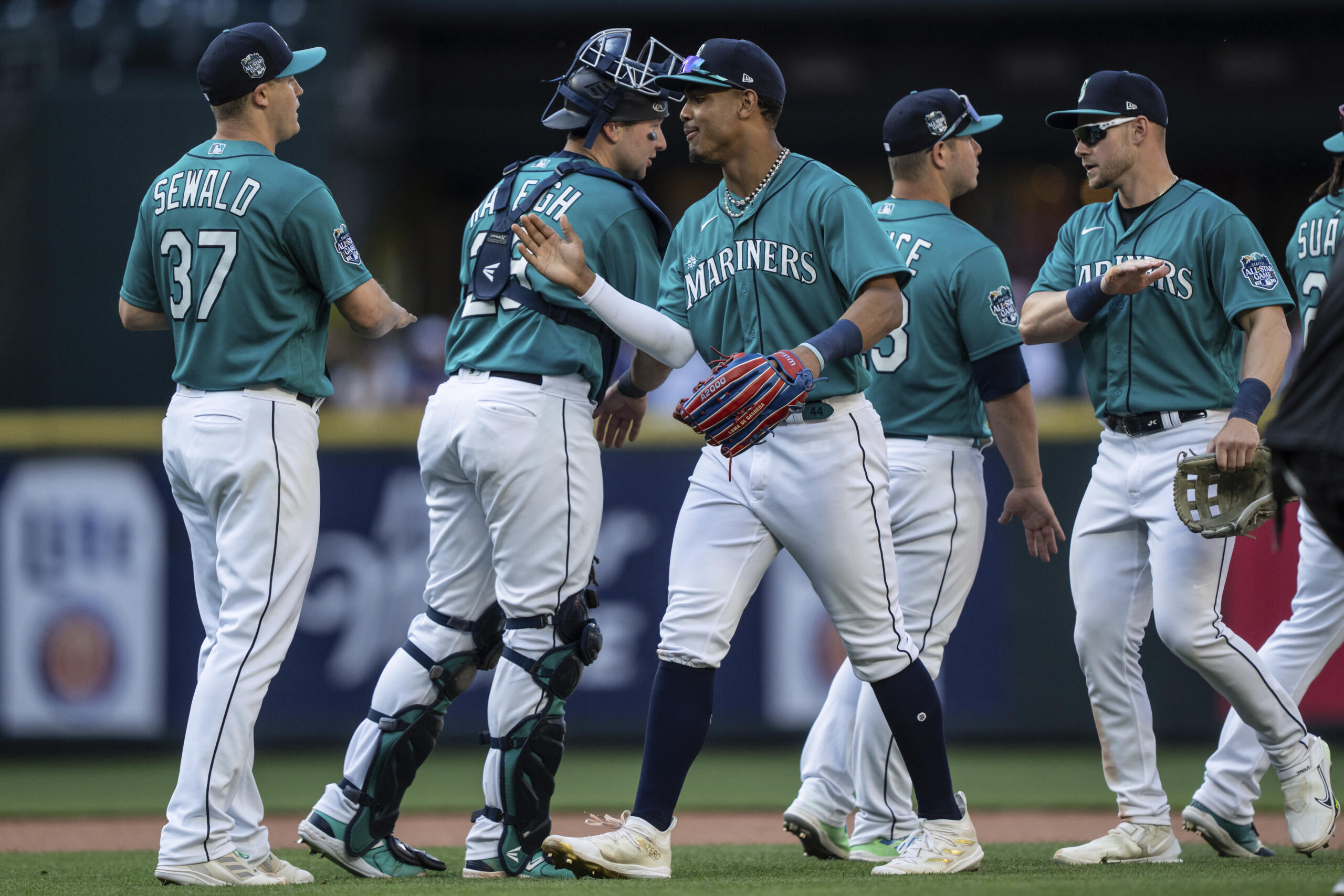 From left to right, Seattle Mariners relief pitcher Paul Sewald, catcher Cal Raleigh, centerfielder Julio Rodriguez, first baseman Ty France and left fielder Jarred Kelenic celebrate after a baseball game against the Tampa Bay Rays, Saturday, July 1, 2023, in Seattle.