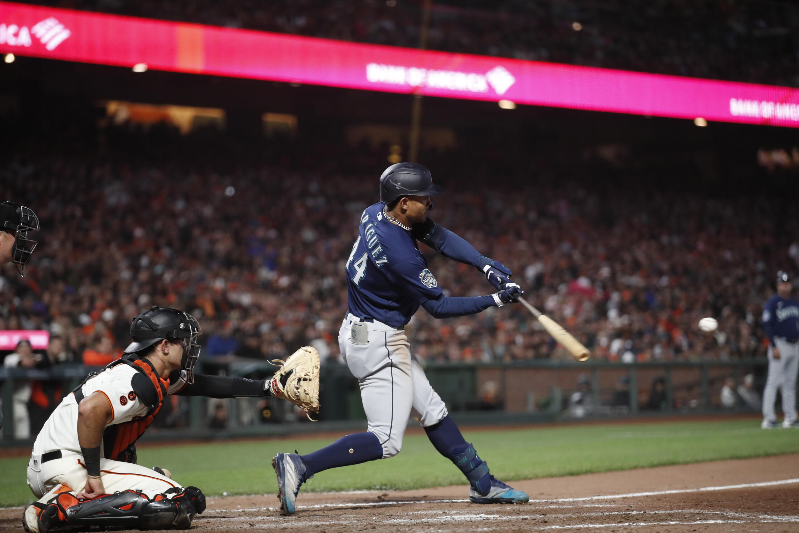 Seattle Mariners' Julio Rodriguez hits a double RBI against San Francisco Giants catcher Blake Sabol (2) in the ninth inning of a baseball game in San Francisco, Monday, July 3, 2023.