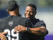 MLB Hall of Fame player Ken Griffey Jr. embraces a member of the coaching staff during a workout session the day before the HBCU Swingman Classic during the 2023 All Star Week, Thursday, July 6, 2023, in Seattle.
