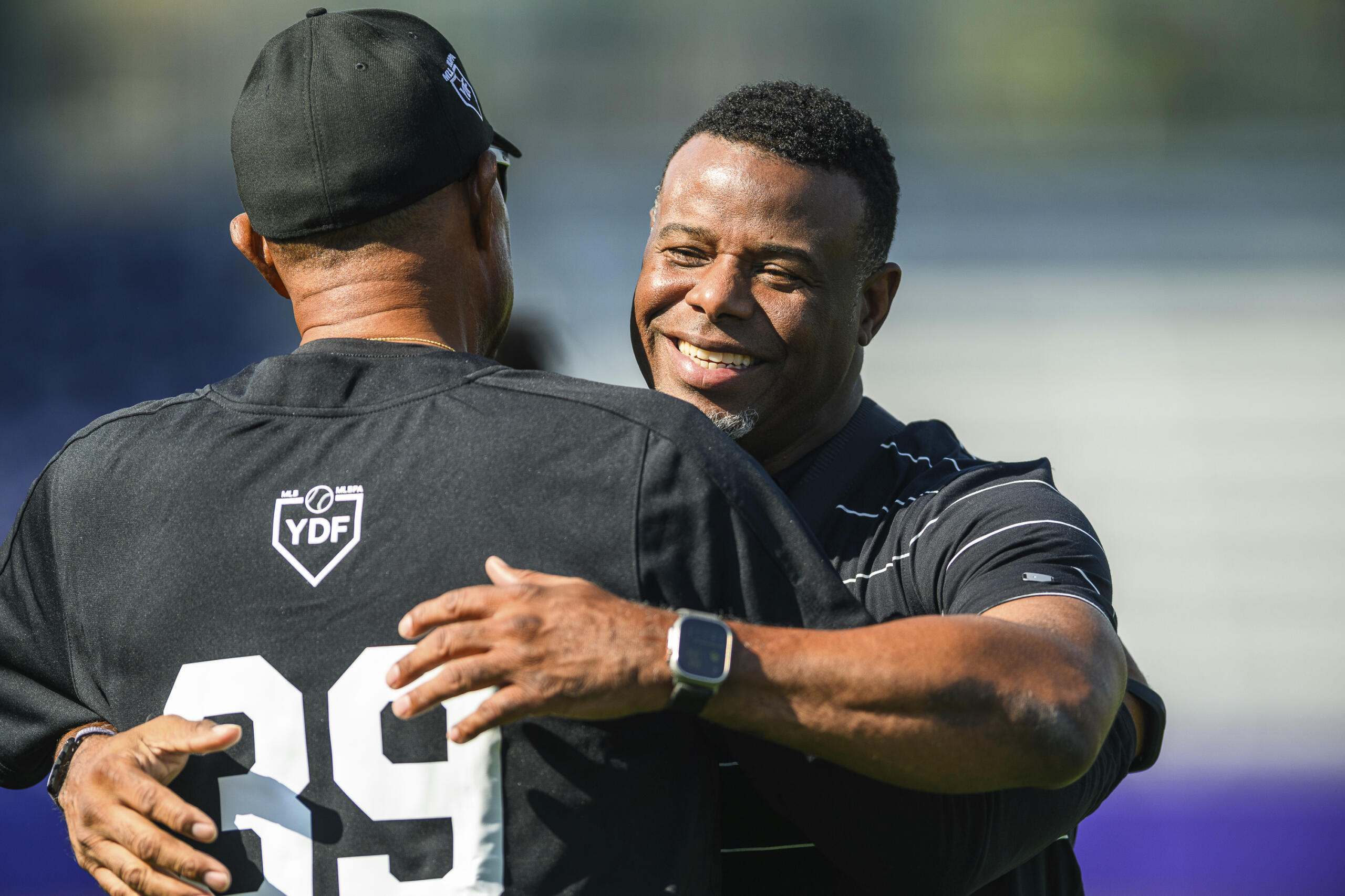 MLB Hall of Fame player Ken Griffey Jr. embraces a member of the coaching staff during a workout session the day before the HBCU Swingman Classic during the 2023 All Star Week, Thursday, July 6, 2023, in Seattle.