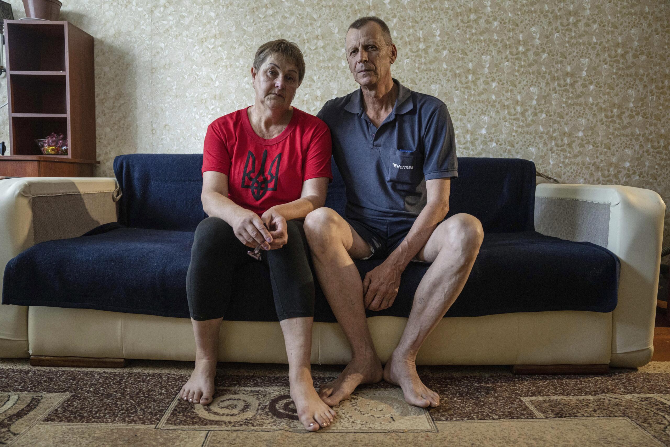 Nataliia Skakun and her husband Serhii, former residents of Oleshky, Ukraine, sit on a sofa at their apartments in Mykolaiv, Ukraine, Tuesday, July 4, 2023. "Young people left, and pensioners stayed," said Skakun, 54, who recently left Oleshky with her husband and resettled in Mykolaiv in the Kherson region.