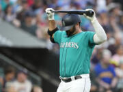 Seattle Mariners' Mike Ford holds his bat above his head after striking out against the Detroit Tigers during the seventh inning of a baseball game Saturday, July 15, 2023, in Seattle.