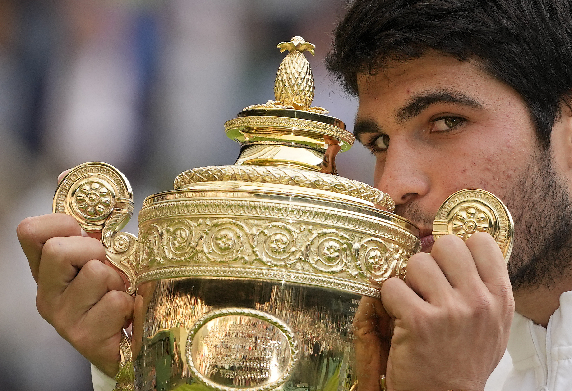 Spain's Carlos Alcaraz celebrates with the trophy after beating Serbia's Novak Djokovic to win the final of the men's singles on day fourteen of the Wimbledon tennis championships in London, Sunday, July 16, 2023.