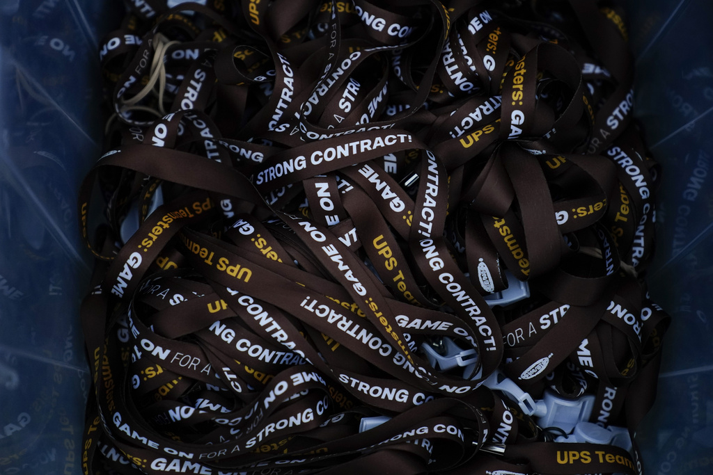 UPS lanyards are seen before a rally, Friday, July 21, 2023, in Atlanta, as a national strike deadline nears. The Teamsters said Friday that they will resume contract negotiations with UPS, marking an end to a stalemate that began two weeks ago when both sides walked away from talks while blaming each other.