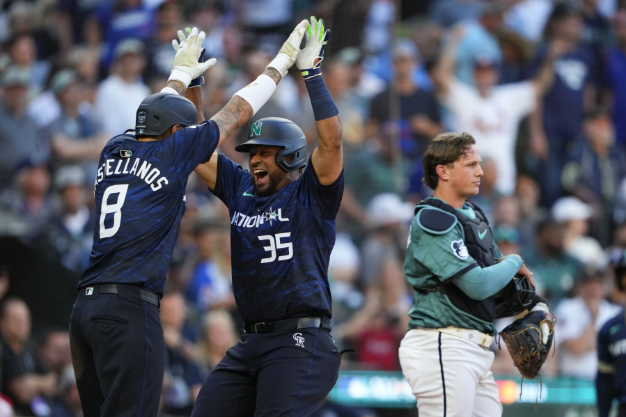 National League's Elias D?az, of the Colorado Rockies (35), celebrates his two run home run with Nick Castellanos (8), of the Philadelphia Phillies, in the eighth inning during the MLB All-Star Game in Seattle, Tuesday. That helped the National League win for the first time since 2012.
