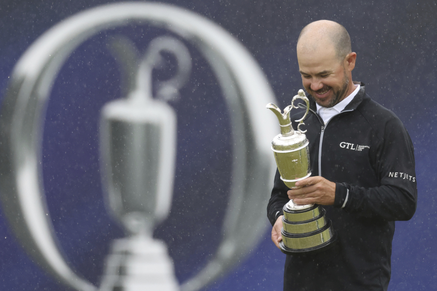 United States' Brian Harman poses for the media as he holds the Claret Jug trophy for winning the British Open Golf Championships at the Royal Liverpool Golf Club in Hoylake, England, Sunday, July 23, 2023.