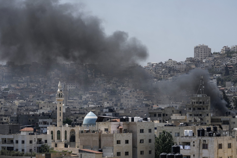 Smoke rises during an Israeli military raid of the militant stronghold of Jenin in the occupied West Bank, Monday, July 3, 2023. Israeli drones struck targets in a militant stronghold in the occupied West Bank early Monday and hundreds of troops were deployed in the area. Palestinian health officials said at least seven Palestinians were killed.