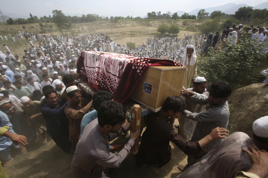 Relatives and mourners carry the casket of a victim, who was killed in Sunday's suicide bomber attack in the Bajur district of Khyber Pakhtunkhwa, Pakistan, Monday, July 31, 2023. Pakistan held funerals on Monday for victims of a massive suicide bombing that targeted a rally of a pro-Taliban cleric the previous day.