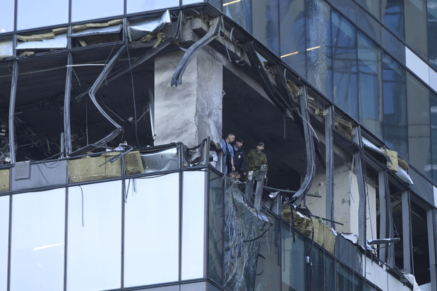 Investigators examine a damaged skyscraper in the "Moscow City" business district after a reported drone attack in Moscow, Russia, early Sunday, July 30, 2023.